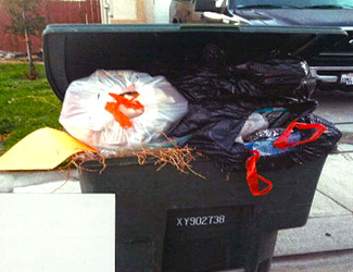 Green waste cart filled with bags